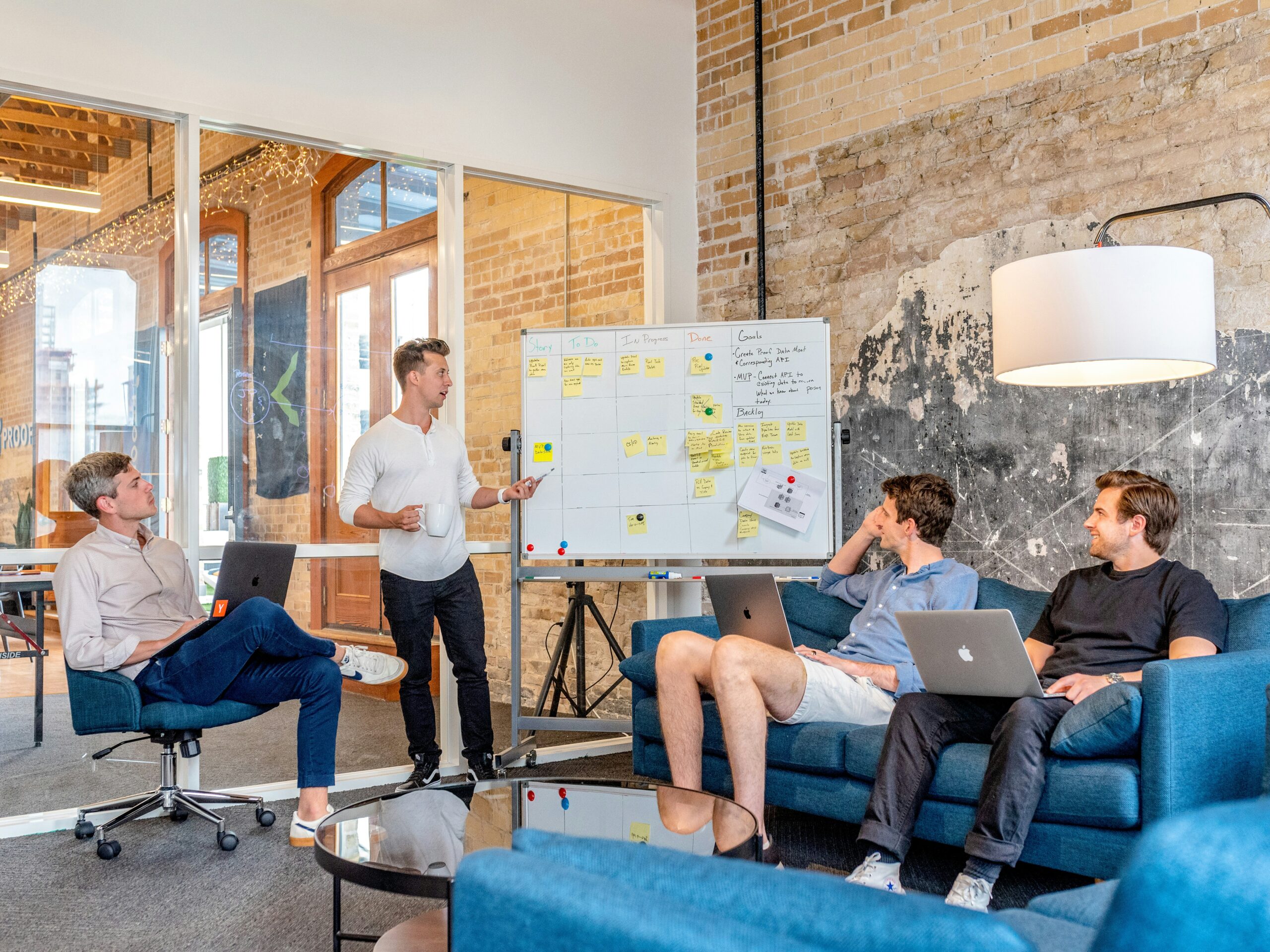 people working infront of whiteboard in meeting room